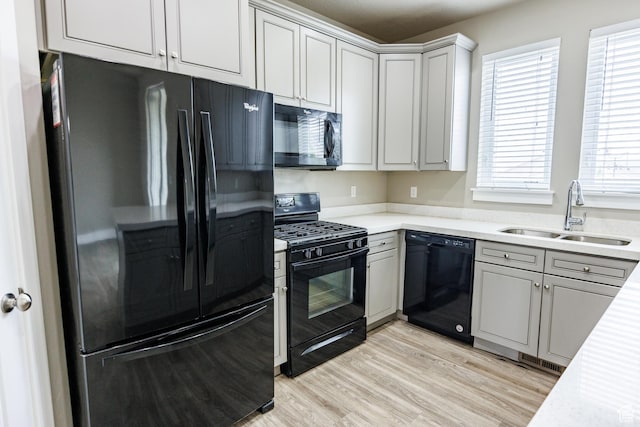972 S High Ridge Rd, Spanish Fork, UT 84660 - kitchen with black appliances, a sink, light countertops, light wood-type flooring, and gray cabinets