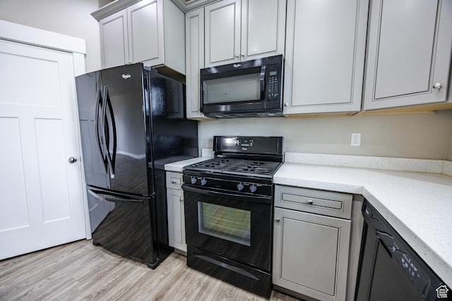 972 S High Ridge Rd, Spanish Fork, UT 84660 - kitchen featuring black appliances, light wood-style flooring, gray cabinetry, and light stone counters