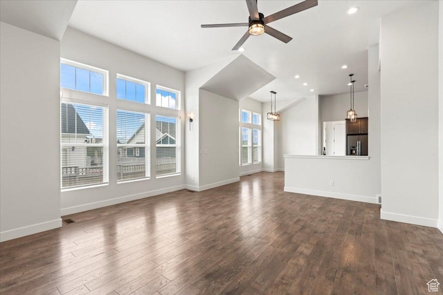 5153 W Lake Terrace Ave S, South Jordan, UT 84009 - unfurnished living room featuring a ceiling fan, baseboards, dark wood finished floors, recessed lighting, and high vaulted ceiling