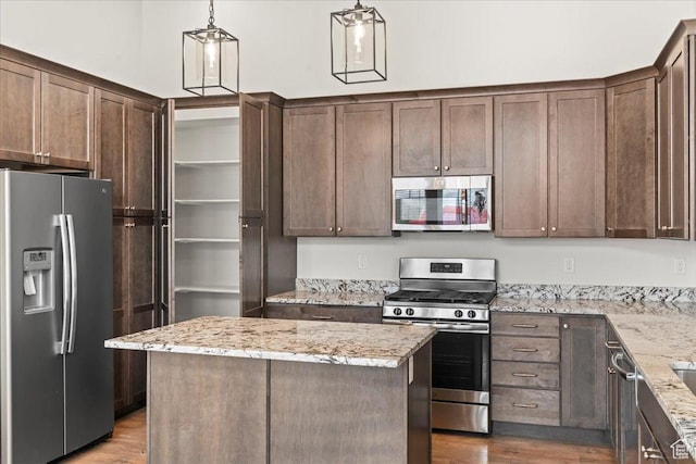 5153 W Lake Terrace Ave S, South Jordan, UT 84009 - kitchen with stainless steel appliances, wood finished floors, dark brown cabinetry, and light stone counters