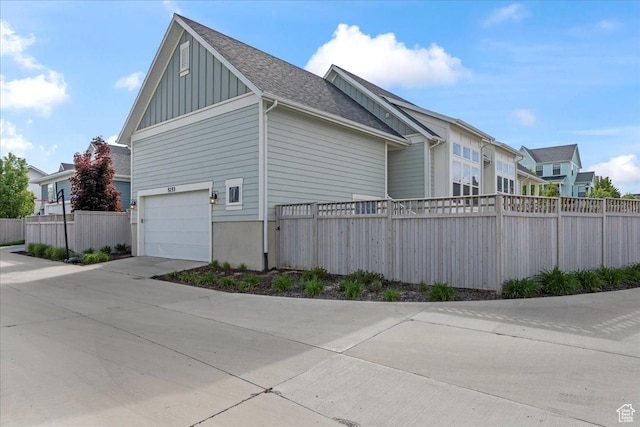 5153 W Lake Terrace Ave S, South Jordan, UT 84009 - view of property exterior featuring fence, an attached garage, board and batten siding, concrete driveway, and roof with shingles