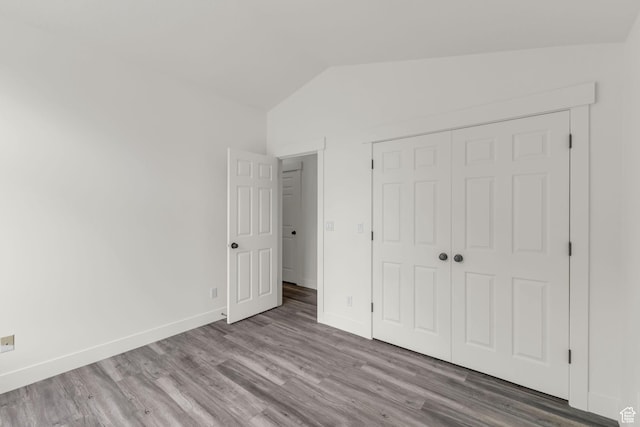 770 W 550 N, Clearfield, UT 84015 - unfurnished bedroom featuring lofted ceiling, wood finished floors, baseboards, and a closet
