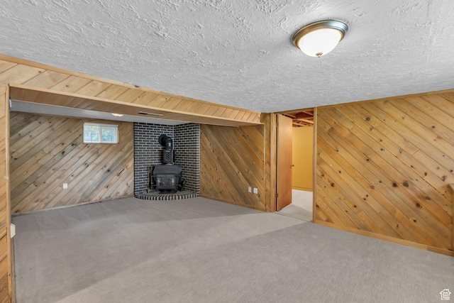 770 W 550 N, Clearfield, UT 84015 - below grade area featuring a wood stove, wooden walls, carpet, and a textured ceiling