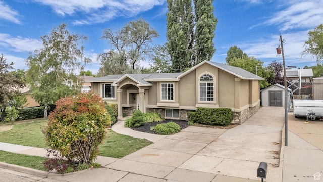 770 W 550 N, Clearfield, UT 84015 - view of front of home featuring a shed, stone siding, stucco siding, an outdoor structure, and concrete driveway