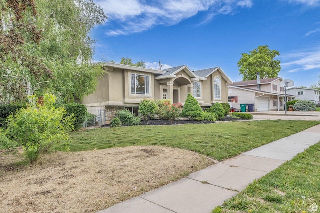 770 W 550 N, Clearfield, UT 84015 - view of front of home featuring stucco siding, a front lawn, and stone siding