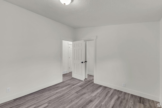 770 W 550 N, Clearfield, UT 84015 - empty room with baseboards, wood finished floors, and a textured ceiling
