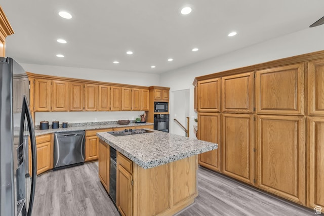 770 W 550 N, Clearfield, UT 84015 - kitchen with black appliances, a center island, light wood finished floors, recessed lighting, and brown cabinets