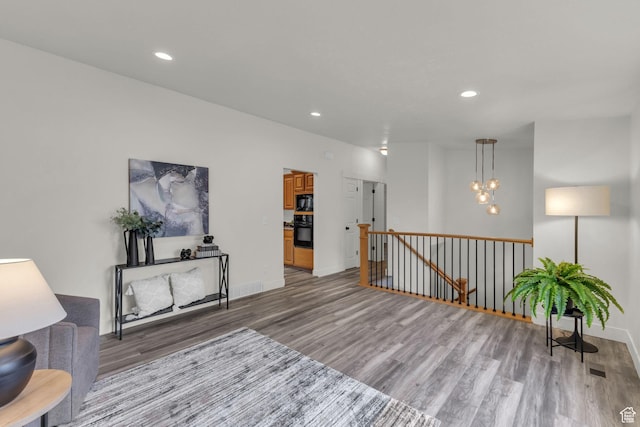 770 W 550 N, Clearfield, UT 84015 - living area with light wood finished floors, an upstairs landing, recessed lighting, baseboards, and a chandelier