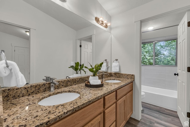 770 W 550 N, Clearfield, UT 84015 - bathroom featuring wood finished floors, double vanity, toilet, and a tub to relax in