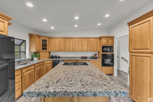 770 W 550 N, Clearfield, UT 84015 - kitchen with black appliances, lofted ceiling, a sink, a center island, and light stone countertops