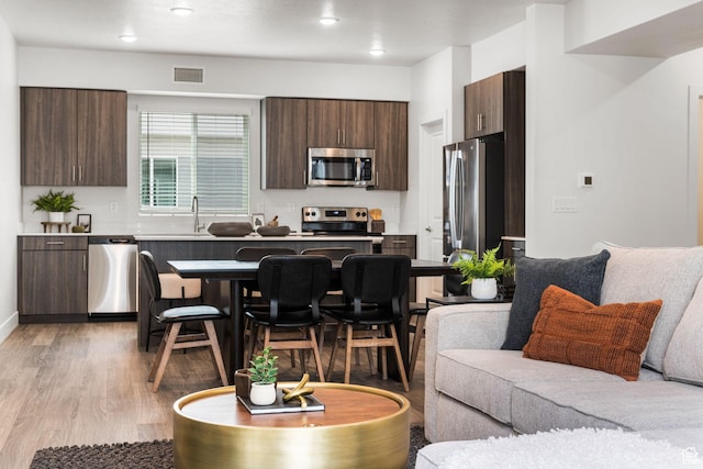 2336 W James Way Unit J34, West Haven, UT 84401 - kitchen with stainless steel appliances, modern cabinets, dark brown cabinets, light wood finished floors, and a sink