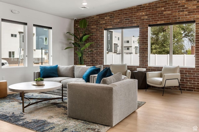 2336 W James Way Unit J34, West Haven, UT 84401 - living room featuring brick wall and light wood-type flooring