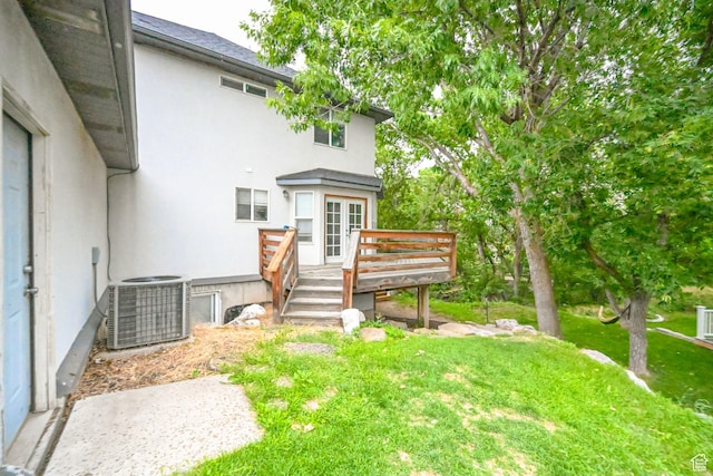 245 E 1400 S, Kaysville, UT 84037 - rear view of property with stucco siding, a deck, central AC unit, and a yard