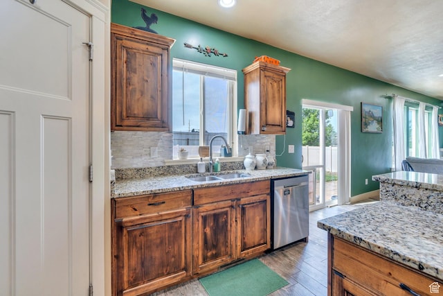 641 W 1450 S, Springville, UT 84663 - kitchen featuring stainless steel dishwasher, a sink, backsplash, light wood finished floors, and brown cabinets