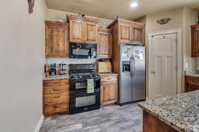 641 W 1450 S, Springville, UT 84663 - kitchen with black appliances, backsplash, baseboards, light stone counters, and brown cabinets