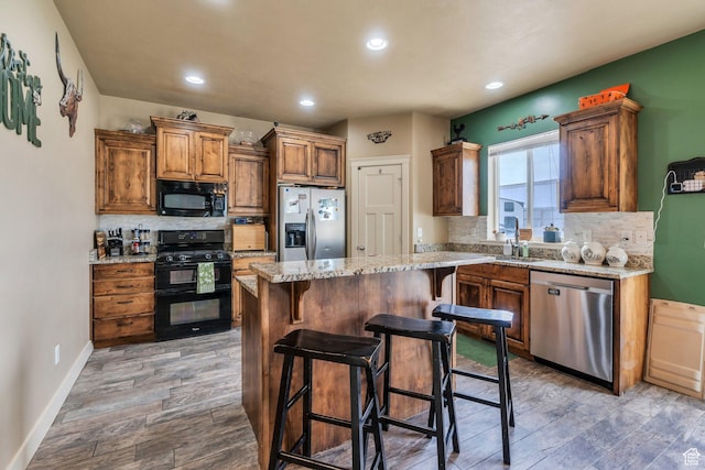 641 W 1450 S, Springville, UT 84663 - kitchen featuring black appliances, decorative backsplash, wood finished floors, a sink, and recessed lighting