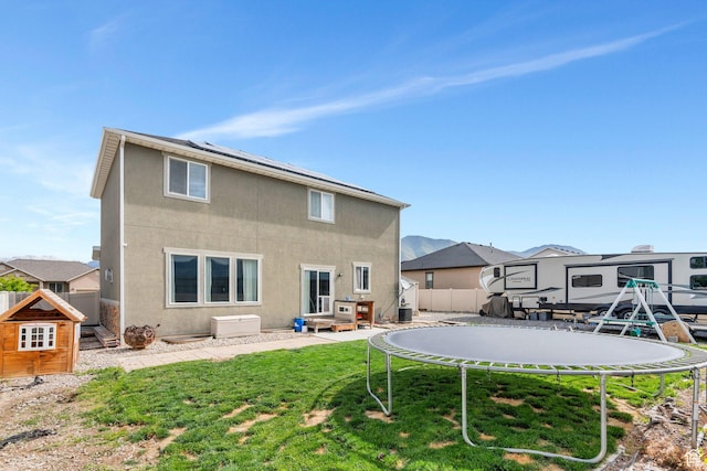 641 W 1450 S, Springville, UT 84663 - rear view of house with a trampoline and stucco siding