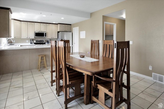 dining space with recessed lighting and baseboards