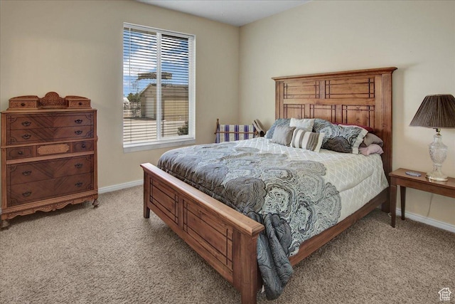 bedroom with light carpet and baseboards
