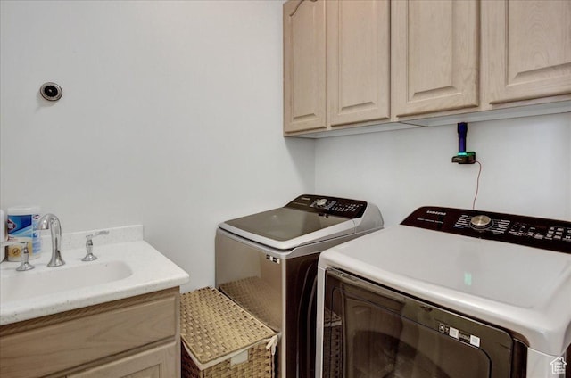clothes washing area with cabinet space and washer and dryer