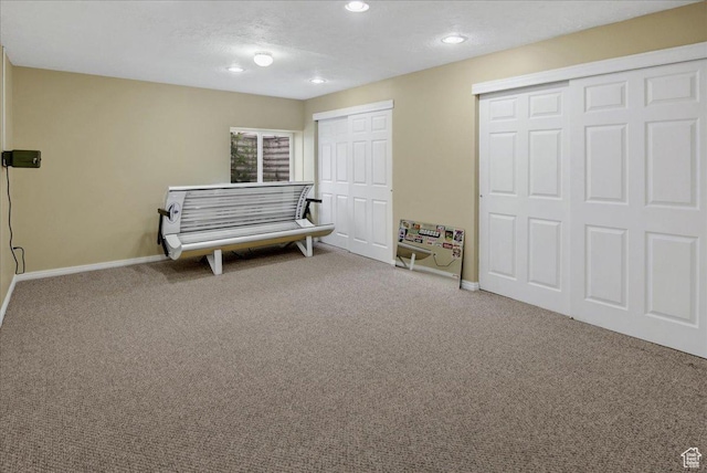 living area with carpet floors, baseboards, and recessed lighting