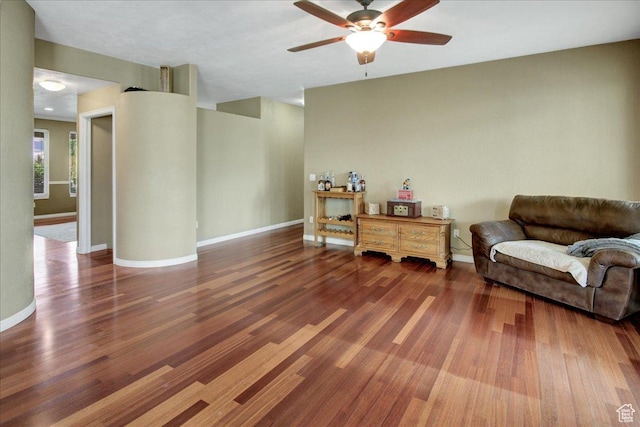 sitting room featuring ceiling fan, wood finished floors, and baseboards