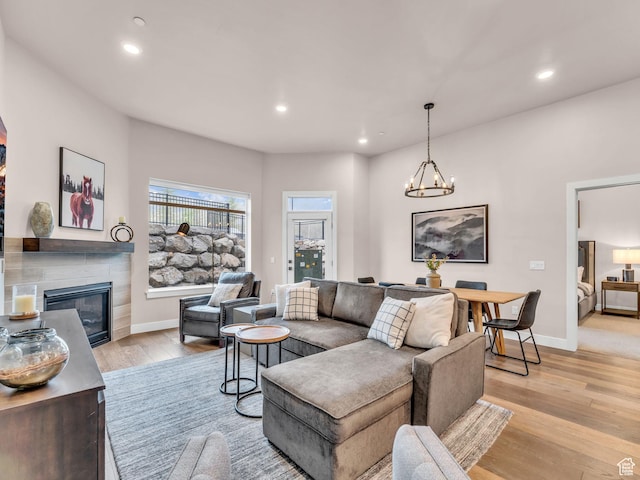 909 W Peace Tree Trl W Unit 416, Heber City, UT 84032 - living area featuring a tile fireplace, light wood finished floors, baseboards, recessed lighting, and a chandelier