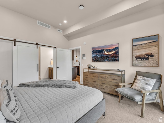 909 W Peace Tree Trl W Unit 416, Heber City, UT 84032 - bedroom featuring a barn door, light carpet, recessed lighting, and ensuite bath