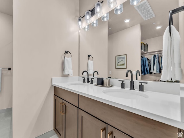 909 W Peace Tree Trl W Unit 416, Heber City, UT 84032 - bathroom featuring a walk in closet, double vanity, and recessed lighting