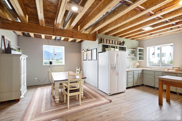 709 W 400 N, Mapleton, UT 84664 - kitchen featuring white refrigerator with ice dispenser, open shelves, a sink, and plenty of natural light