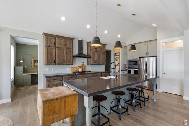 709 W 400 N, Mapleton, UT 84664 - kitchen featuring wall chimney exhaust hood, appliances with stainless steel finishes, dark countertops, a sink, and light wood-style flooring