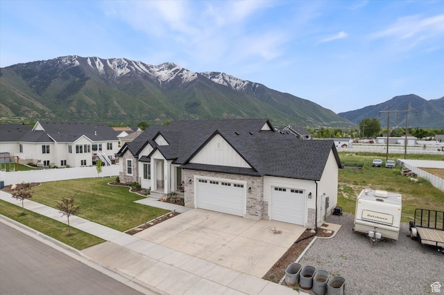 709 W 400 N, Mapleton, UT 84664 - view of front of house with stone siding, a garage, driveway, a mountain view, and board and batten siding