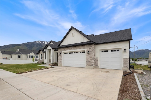 709 W 400 N, Mapleton, UT 84664 - view of front of property with board and batten siding, a mountain view, concrete driveway, and stone siding