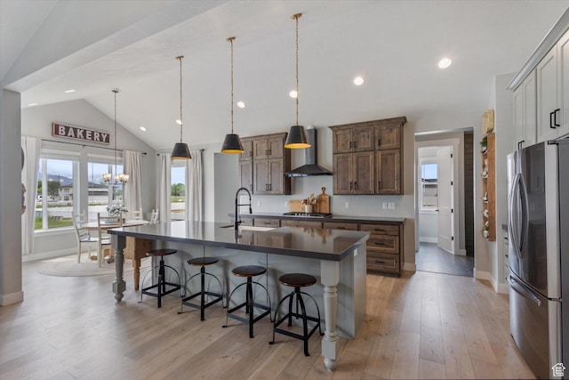 709 W 400 N, Mapleton, UT 84664 - kitchen featuring appliances with stainless steel finishes, wall chimney exhaust hood, a sink, dark countertops, and baseboards