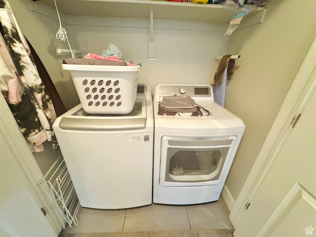 laundry room with separate washer and dryer and tile patterned floors