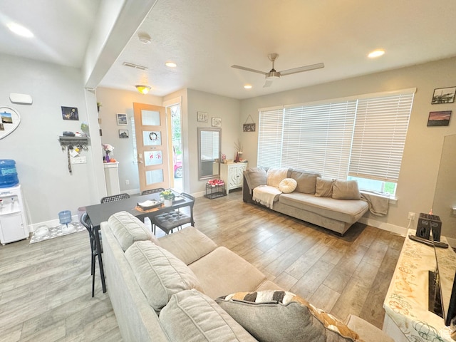 living room with wood finished floors, recessed lighting, ceiling fan, and baseboards