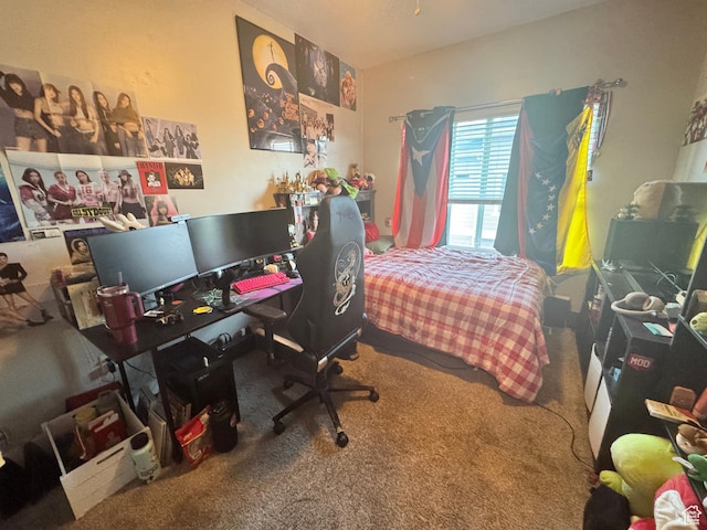carpeted bedroom featuring a desk