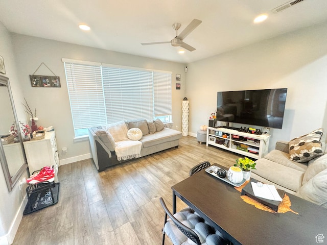 living room with ceiling fan, wood finished floors, baseboards, and recessed lighting