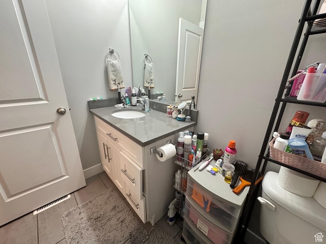 bathroom with vanity, tile patterned floors, and toilet