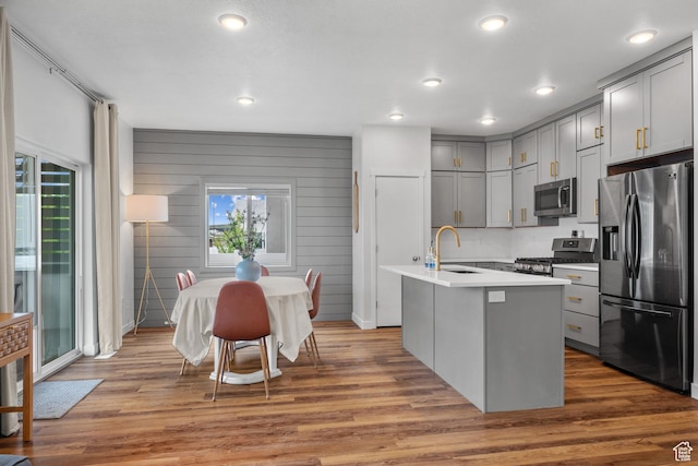 6613 S Ellerston Dr W, Murray, UT 84123 - kitchen with stainless steel appliances, gray cabinets, a sink, light countertops, and wood finished floors