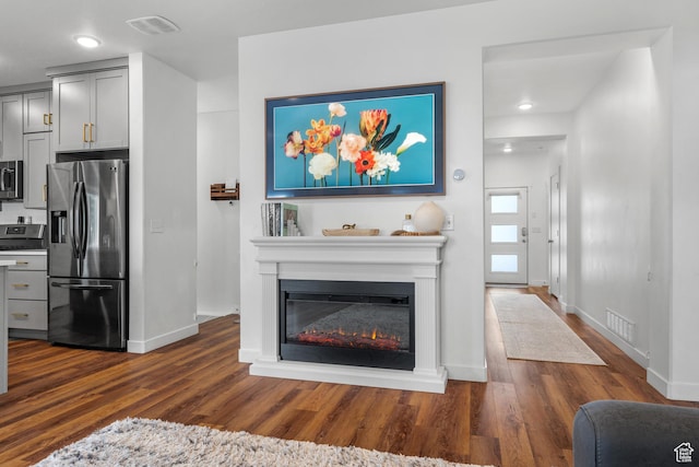 6613 S Ellerston Dr W, Murray, UT 84123 - living area with dark wood-type flooring, baseboards, a glass covered fireplace, and recessed lighting