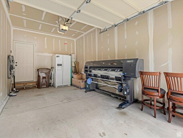 14910 S Ox Cart Ln, Draper, UT 84020 - garage with white fridge with ice dispenser and a garage door opener