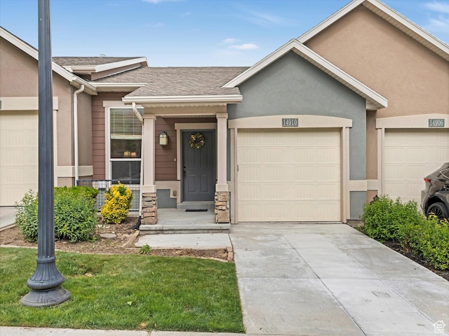 14910 S Ox Cart Ln, Draper, UT 84020 - view of front of house featuring a garage, driveway, roof with shingles, and stucco siding