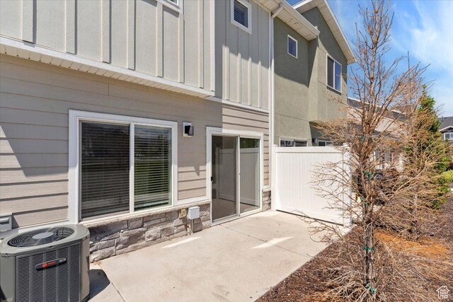 1862 S 1280 W, Logan, UT 84321 - back of house featuring central AC unit, board and batten siding, a patio area, and stone siding