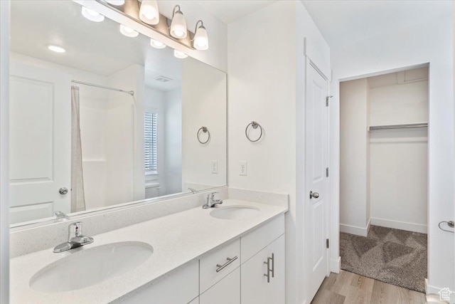 1908 S 1280 W, Logan, UT 84321 - full bath featuring double vanity, wood finished floors, a shower, baseboards, and a walk in closet