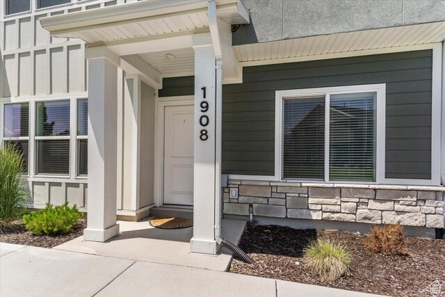 1908 S 1280 W, Logan, UT 84321 - property entrance with board and batten siding, stone siding, and a porch