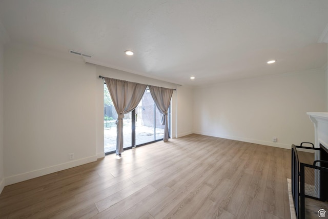 4604 S Woodduck Ln, Millcreek, UT 84117 - unfurnished living room with light wood-style floors, baseboards, recessed lighting, and crown molding