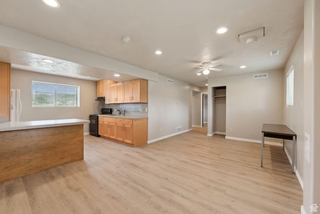 kitchen featuring black range with electric stovetop, light wood-type flooring, recessed lighting, light countertops, and a ceiling fan