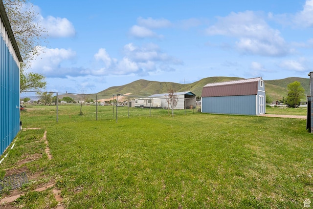 view of yard with a mountain view and an outbuilding