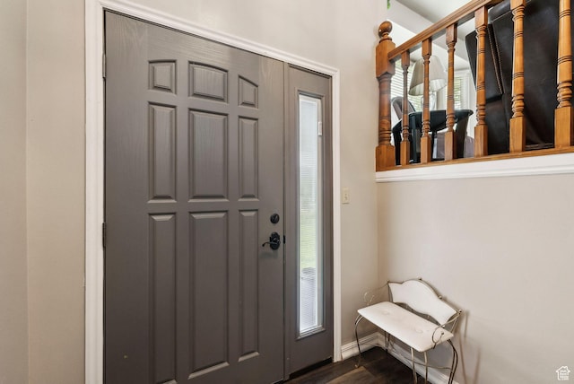 entryway featuring dark wood-style floors and baseboards